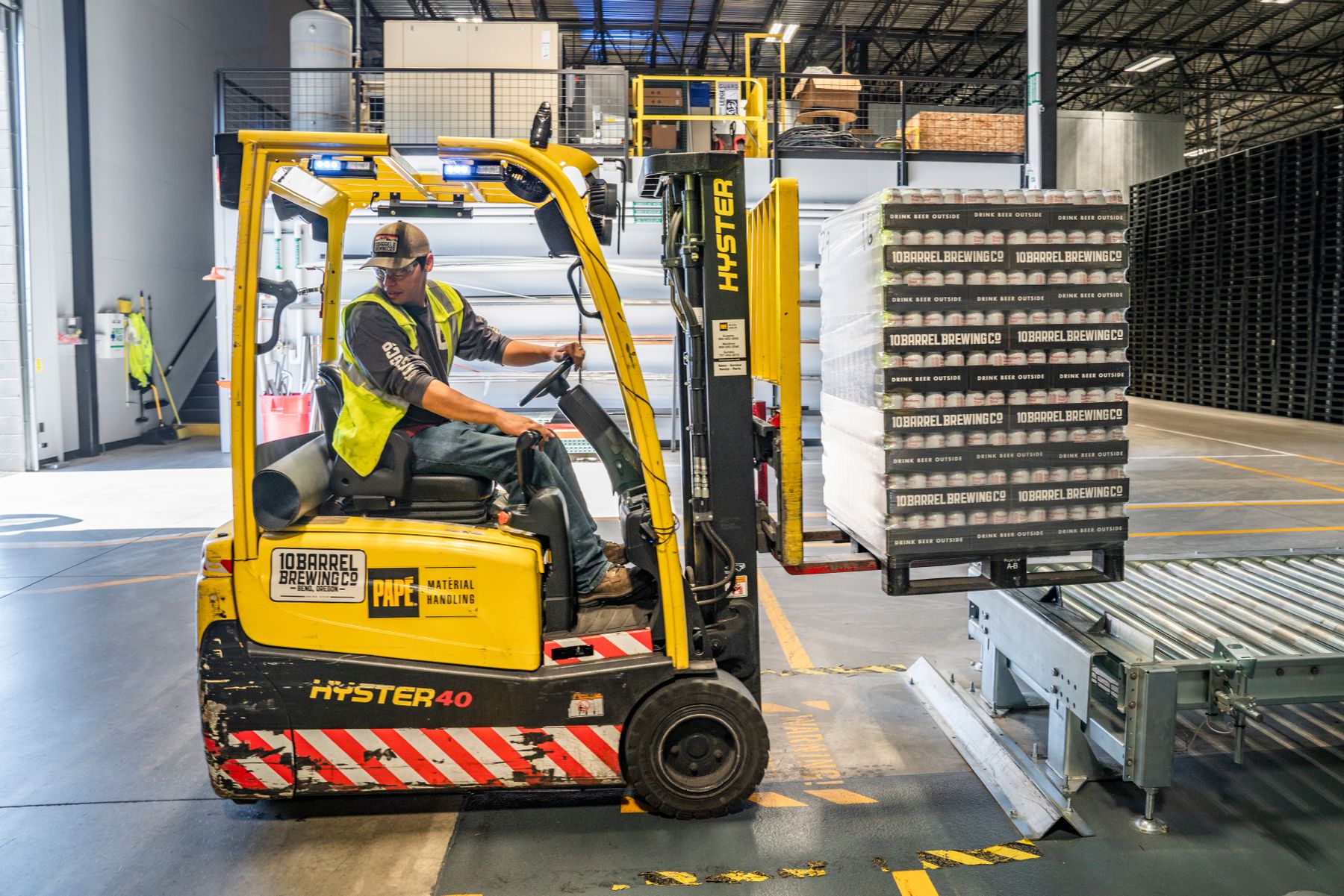 A warehouse employee operating a forklift