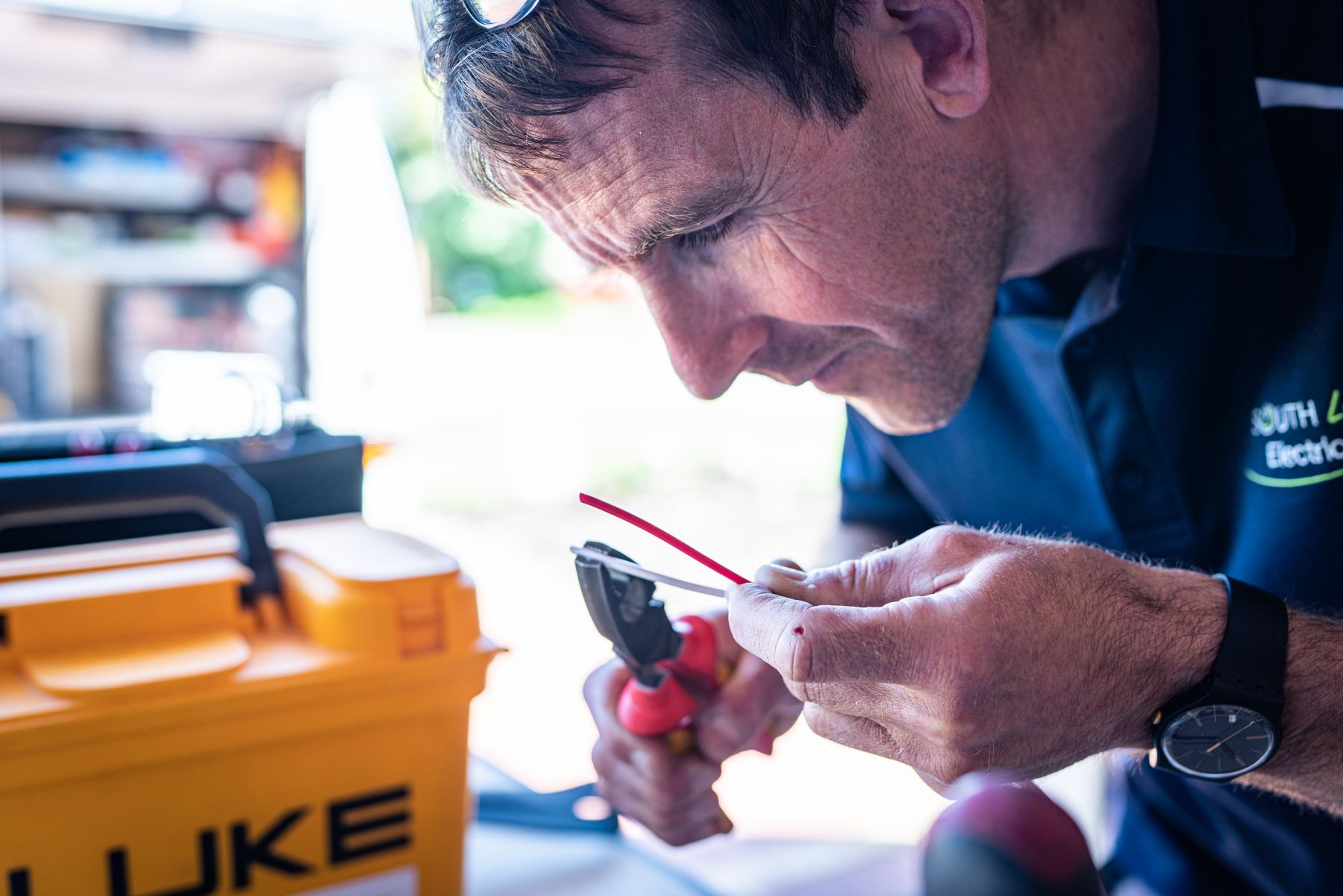An electrical technician preparing wiring for installation